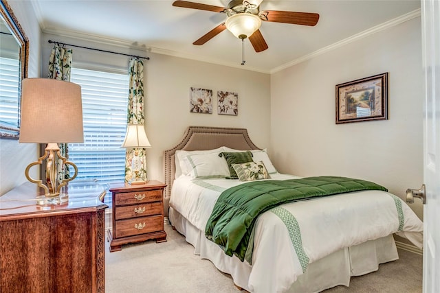 carpeted bedroom featuring ceiling fan and crown molding