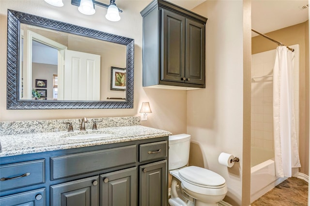 bathroom featuring vanity, toilet, and shower / bath combo with shower curtain