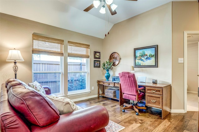 office featuring lofted ceiling, ceiling fan, baseboards, and wood finished floors