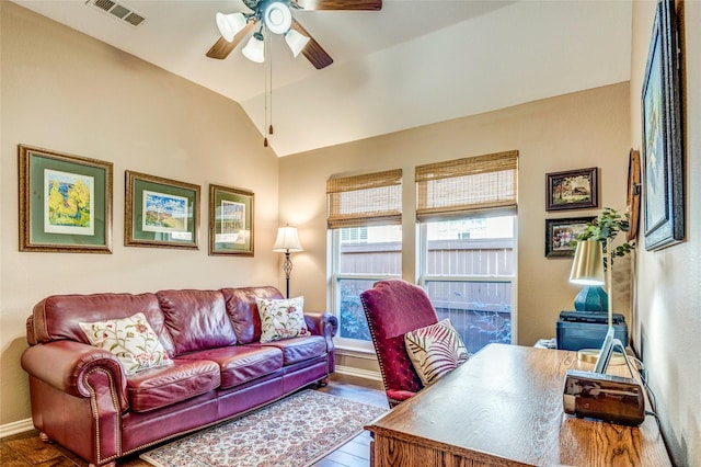 office featuring lofted ceiling, ceiling fan, wood finished floors, visible vents, and baseboards