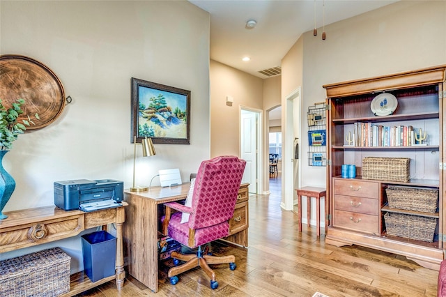 office space with recessed lighting, visible vents, and wood finished floors