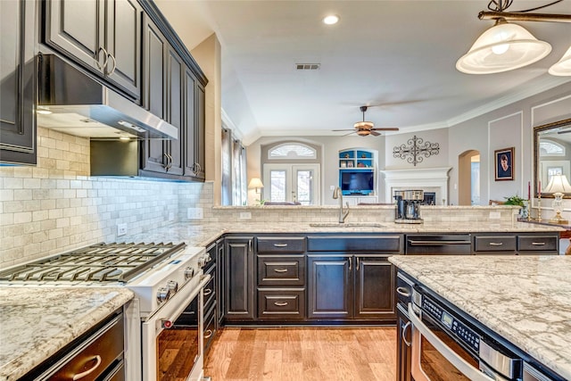 kitchen with visible vents, range with gas stovetop, crown molding, under cabinet range hood, and a sink