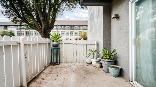 view of patio / terrace with a residential view and fence