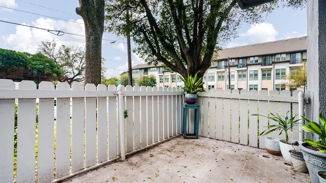 view of patio / terrace with fence and a residential view