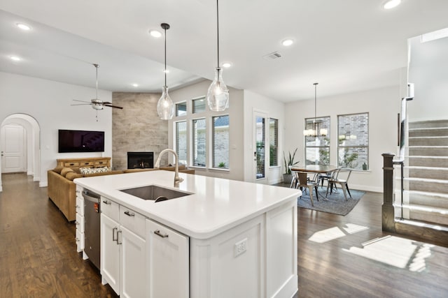 kitchen featuring a high end fireplace, open floor plan, a sink, and recessed lighting