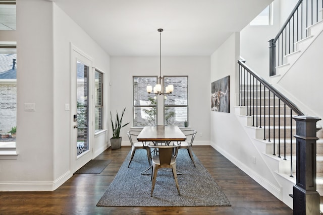 dining space featuring a chandelier, wood finished floors, stairs, and baseboards