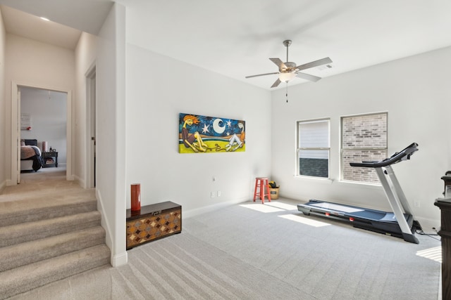 workout room featuring carpet flooring, ceiling fan, and baseboards