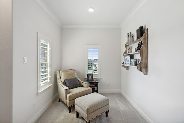 sitting room featuring light carpet, crown molding, and baseboards