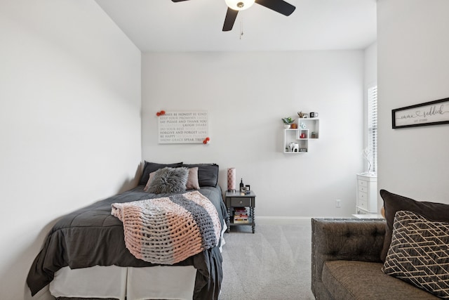 carpeted bedroom with baseboards and a ceiling fan