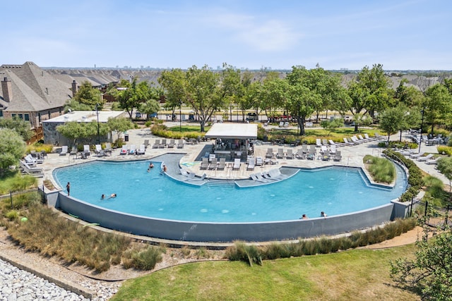 view of pool featuring fence and a patio