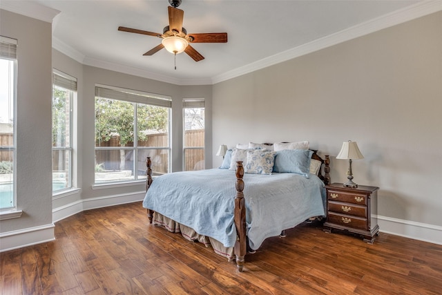 bedroom featuring crown molding, multiple windows, baseboards, and wood finished floors