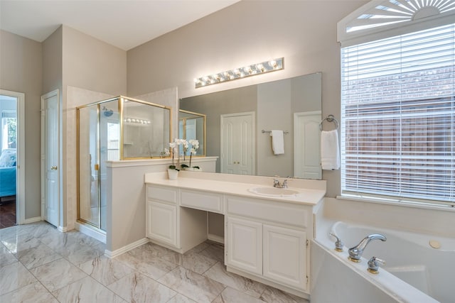 bathroom featuring a stall shower, marble finish floor, a bath, and vanity