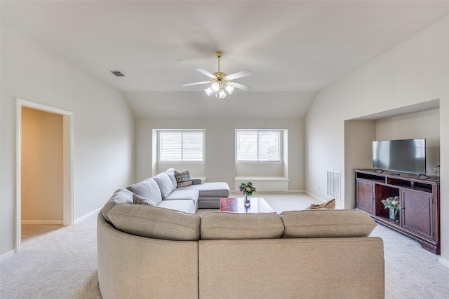 living area featuring lofted ceiling, visible vents, light carpet, ceiling fan, and baseboards