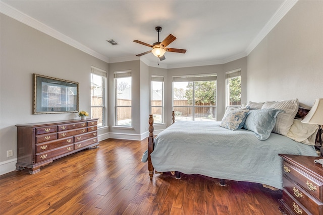 bedroom featuring ornamental molding, multiple windows, wood finished floors, and visible vents