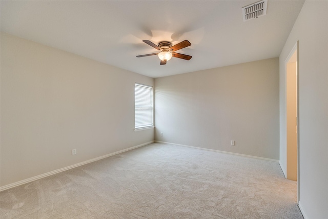 unfurnished room with baseboards, carpet, visible vents, and a ceiling fan