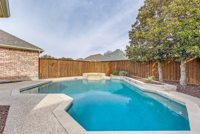 view of pool with a fenced backyard, a pool with connected hot tub, and a patio