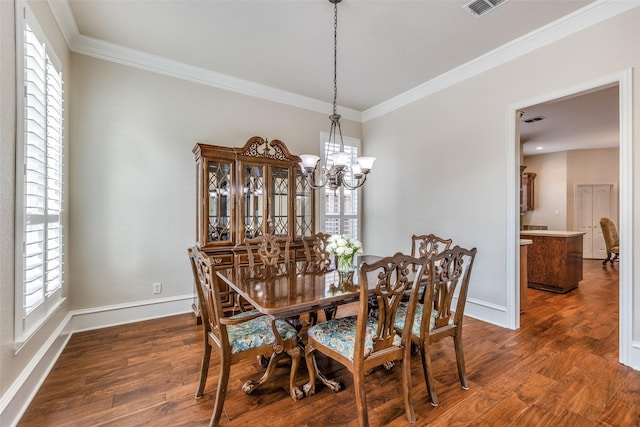 dining room with dark wood-type flooring, a notable chandelier, plenty of natural light, and ornamental molding