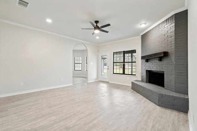 unfurnished living room with a fireplace, visible vents, ceiling fan, wood finished floors, and baseboards