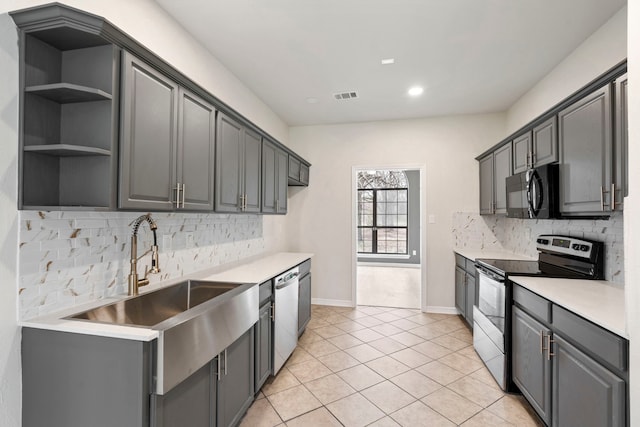 kitchen with light tile patterned floors, light countertops, visible vents, appliances with stainless steel finishes, and a sink