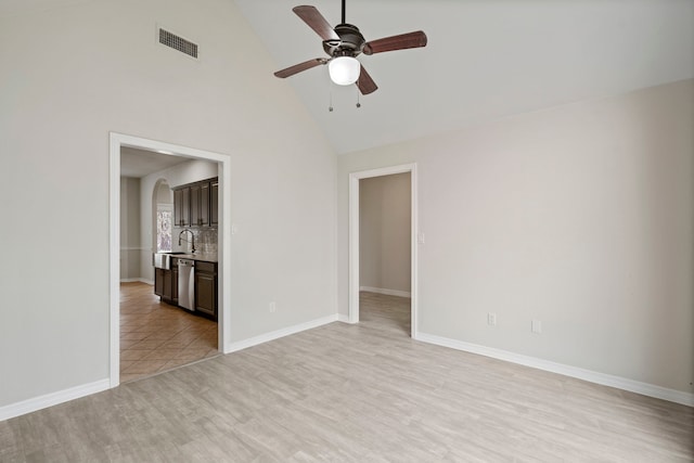 unfurnished room featuring arched walkways, ceiling fan, visible vents, baseboards, and light wood-style floors