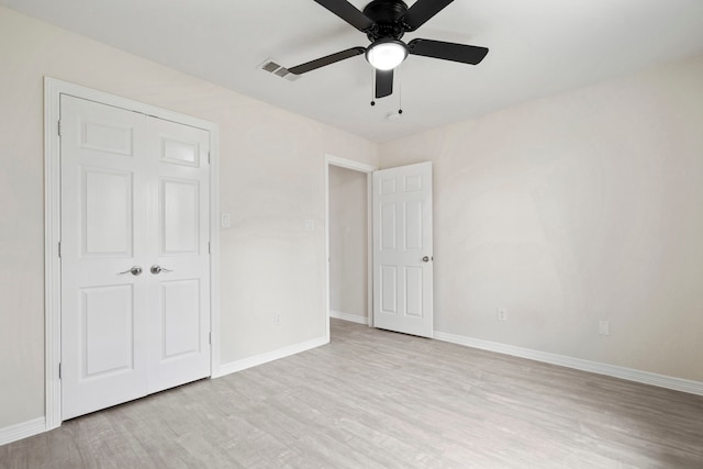 unfurnished bedroom featuring wood finished floors, visible vents, and baseboards