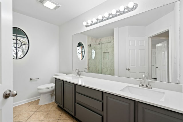 bathroom featuring visible vents, a sink, toilet, and a shower stall