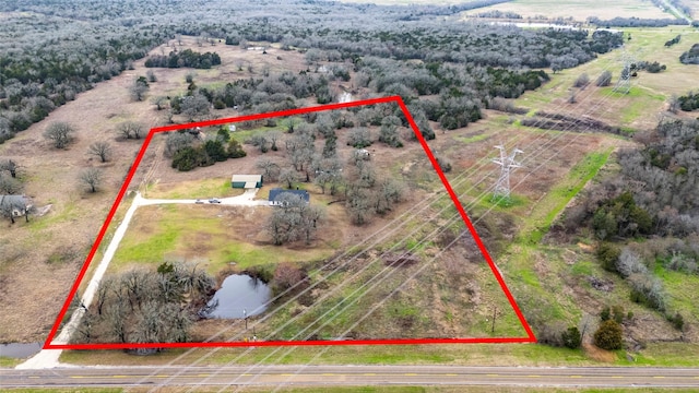 birds eye view of property with a rural view