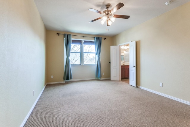 unfurnished room featuring baseboards, ceiling fan, and light colored carpet