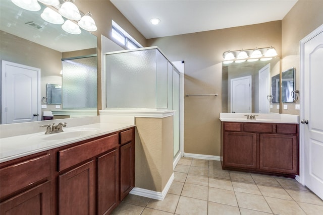 full bathroom featuring tile patterned flooring, a sink, and a shower stall