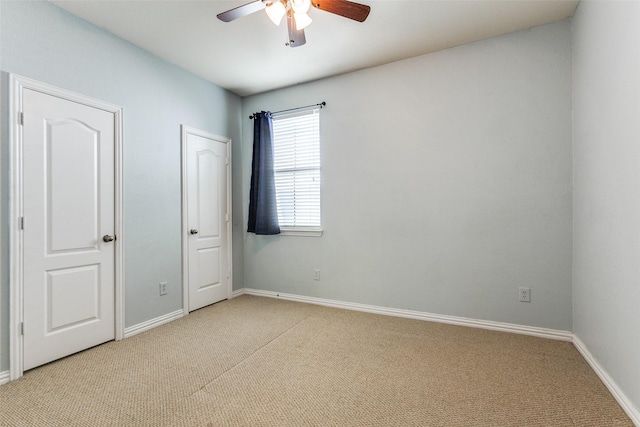 unfurnished bedroom featuring ceiling fan, carpet, and baseboards