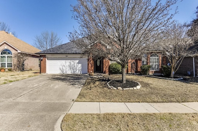 view of front facade with a garage, driveway, and brick siding