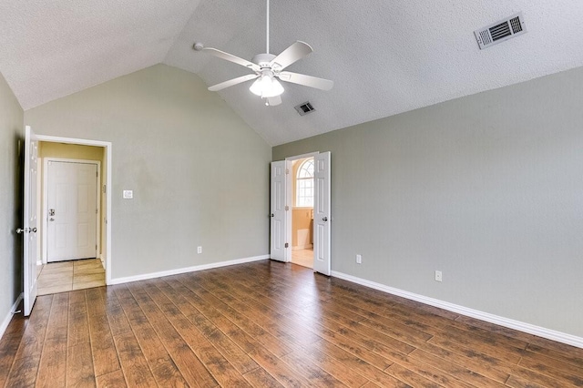 empty room with a ceiling fan, visible vents, and wood finished floors