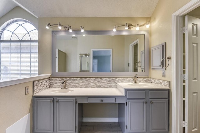 bathroom with double vanity, a sink, and a wealth of natural light