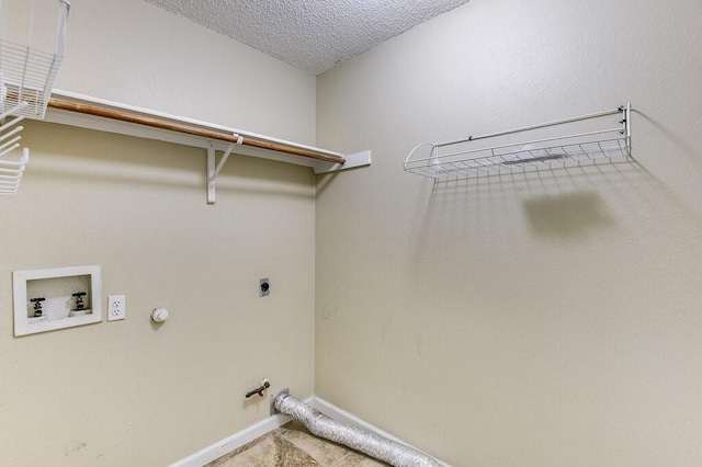 laundry area featuring hookup for a washing machine, hookup for a gas dryer, hookup for an electric dryer, a textured ceiling, and laundry area