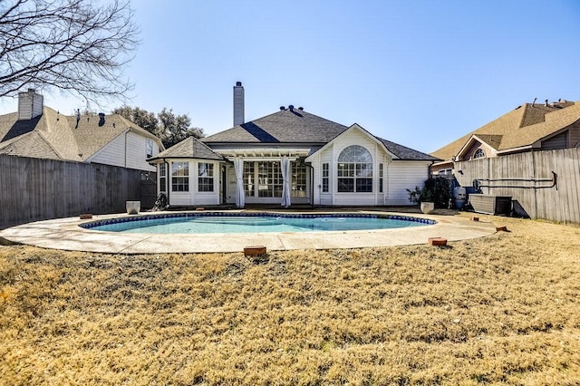 back of property featuring a patio area, a fenced backyard, and a fenced in pool