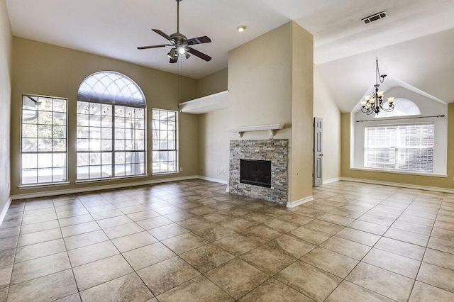 unfurnished living room with visible vents, a stone fireplace, tile patterned flooring, baseboards, and ceiling fan with notable chandelier