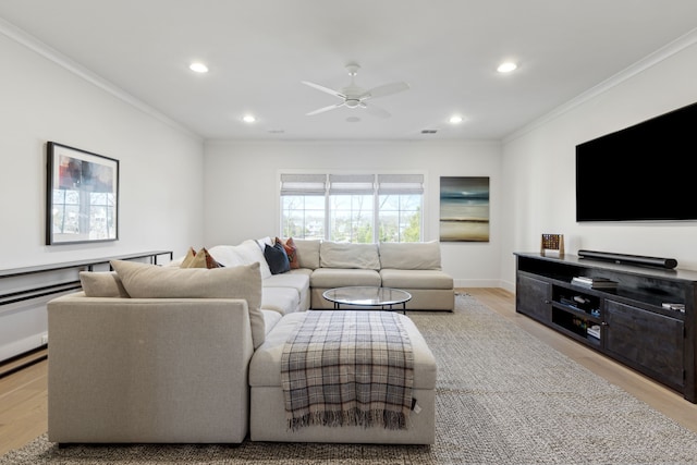 living area with light wood-style flooring, crown molding, and recessed lighting