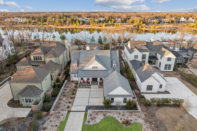 drone / aerial view with a residential view and a water view