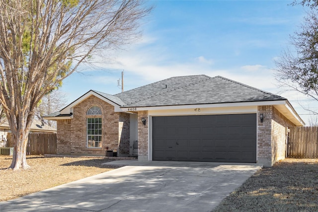 single story home with a garage, driveway, brick siding, and fence