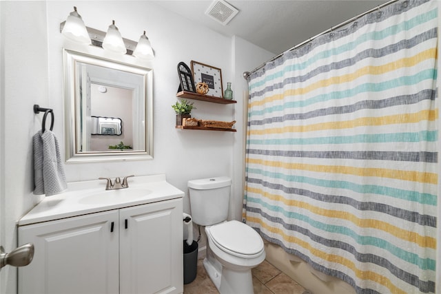 bathroom featuring visible vents, toilet, shower / bath combo with shower curtain, vanity, and tile patterned flooring