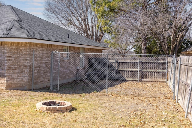 view of yard with fence private yard and a fire pit