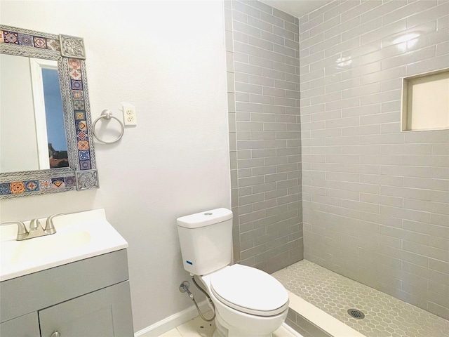 bathroom featuring baseboards, vanity, toilet, and a shower stall