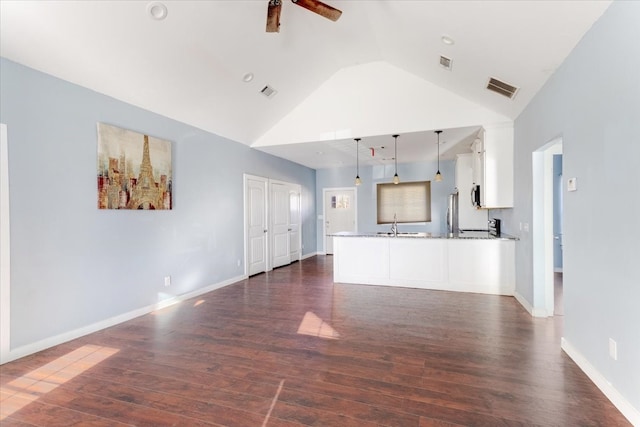 unfurnished living room featuring baseboards, visible vents, and dark wood-style flooring