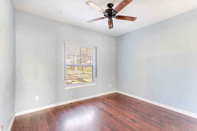 empty room featuring hardwood / wood-style floors, a ceiling fan, and baseboards