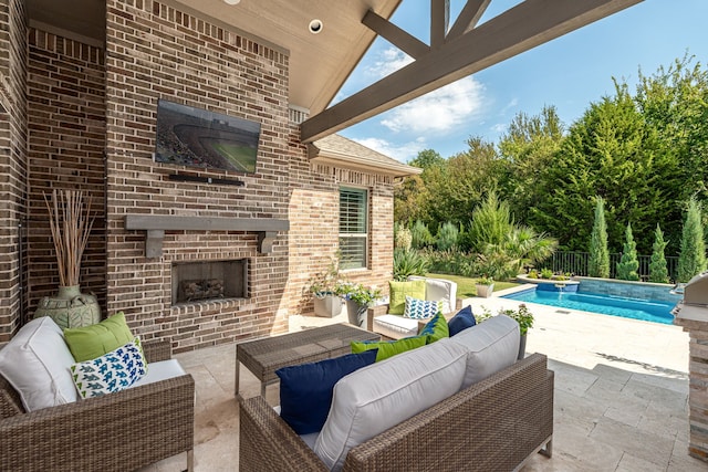 view of patio / terrace featuring an outdoor living space with a fireplace and an outdoor pool