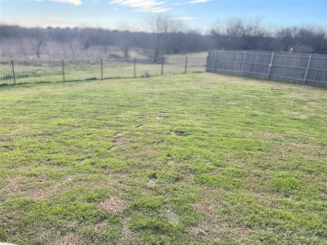 view of yard with a rural view and fence