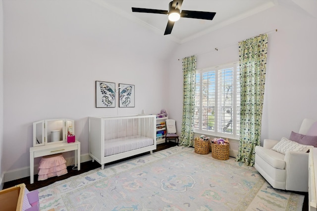 living area featuring crown molding, lofted ceiling, ceiling fan, and baseboards