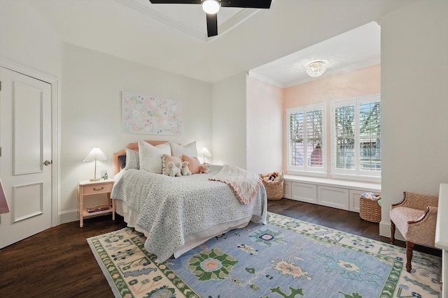 bedroom with dark wood-style floors, ornamental molding, and a ceiling fan