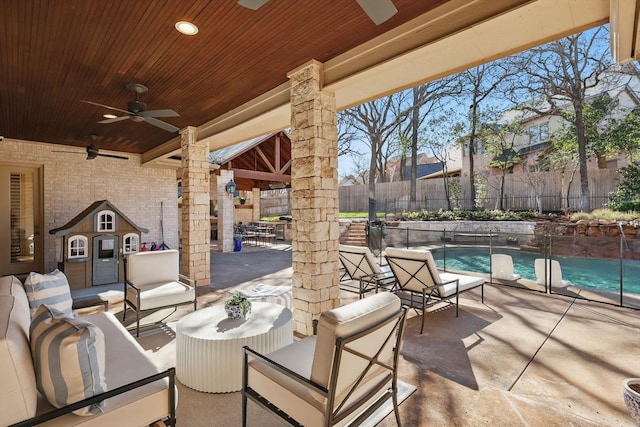 view of patio with an outdoor living space, fence, a fenced in pool, and a ceiling fan