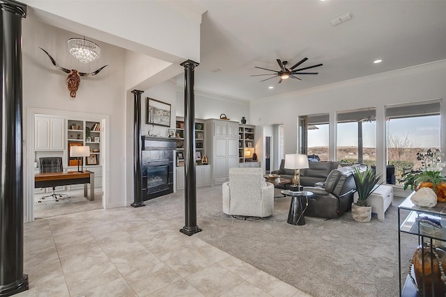 living room featuring decorative columns, visible vents, ornamental molding, light carpet, and ceiling fan